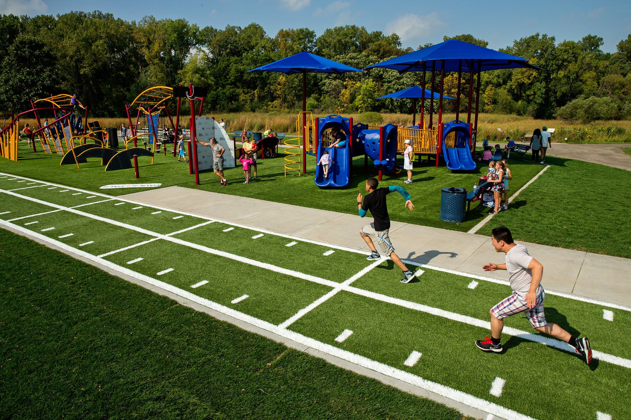 children running on outdoor obstacle course