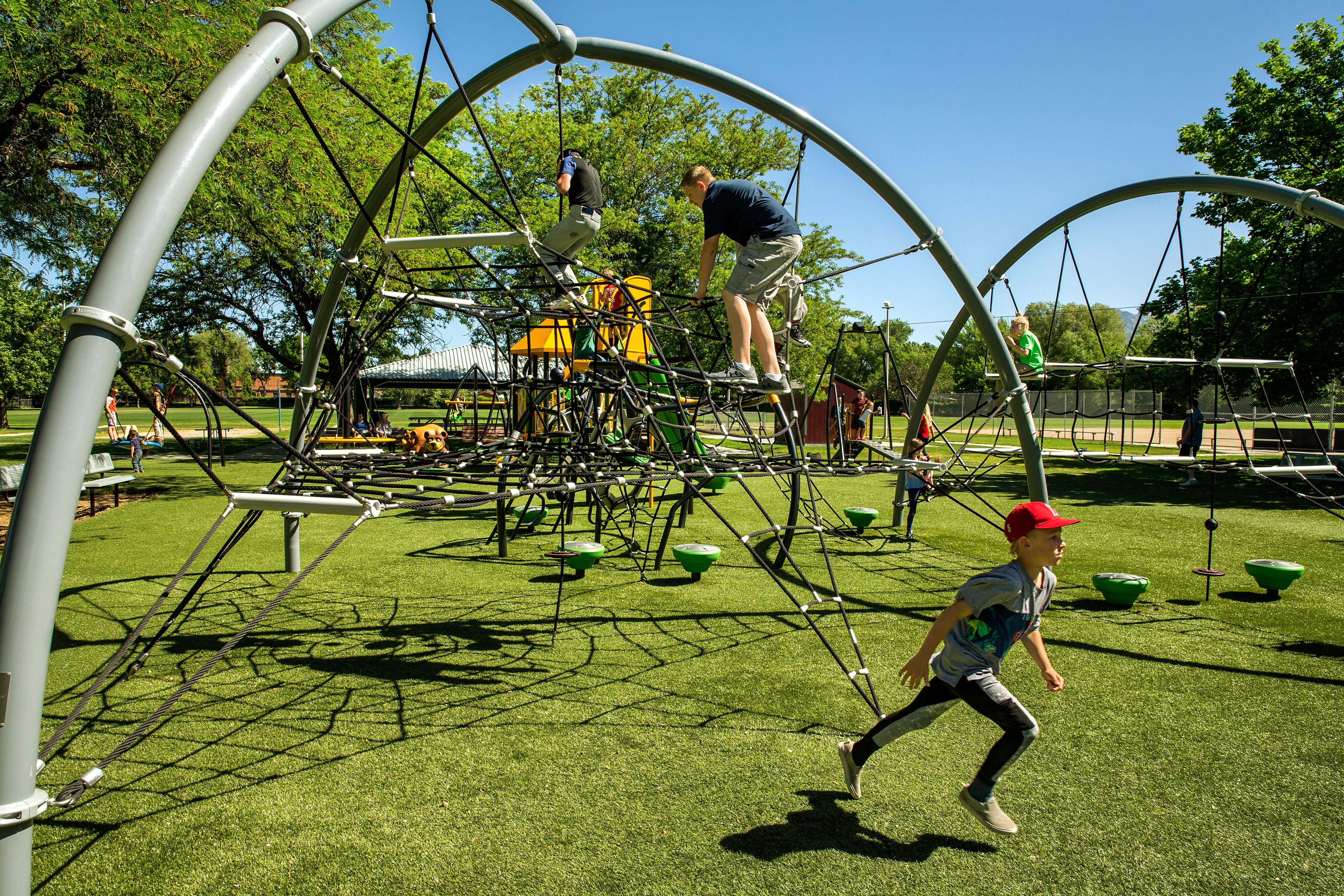 children climbing on net on playground